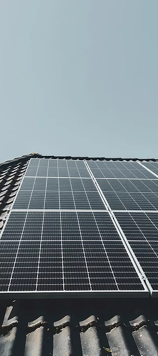 Solarpanels auf einem Ziegeldach unter klarem Himmel