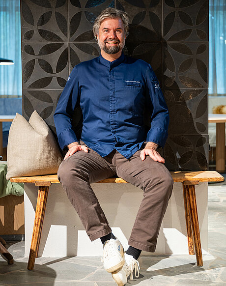 Thomas Gruber Executive Chef im Haus Zirngast sitzend am Kamin im Gasthaus
