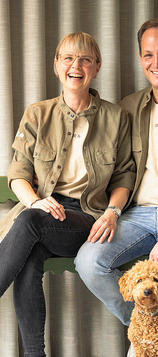 Hosts Andrea and Marcel Zirngast with their miniature poodle Sunny at Haus Zirngast